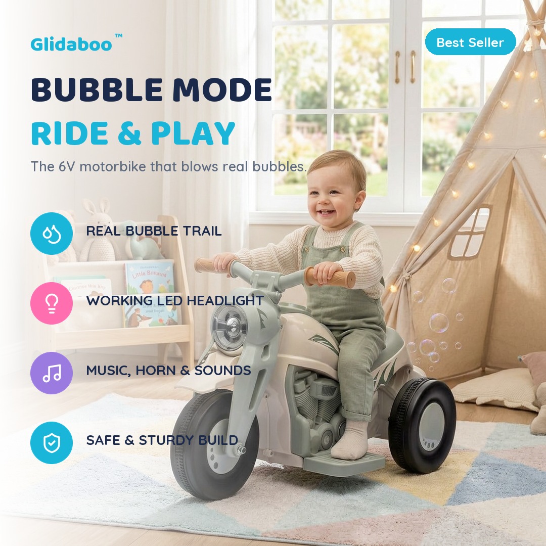 Happy toddler riding the pink Glidaboo bubble ride-on motorbike in a bright living room